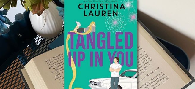 Tangled Up In You Book cover on an open book beside a flower pot, with five stars